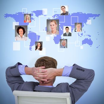 Relaxed businessman extended on a chair against blue background