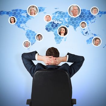 Businessman sitting in swivel chair  against background with hexagons and world map