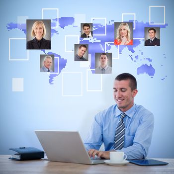 Smiling businessman working with his laptop against blue background