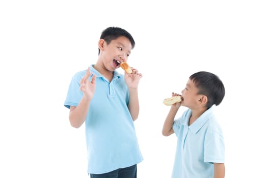 Asian kids eating cake