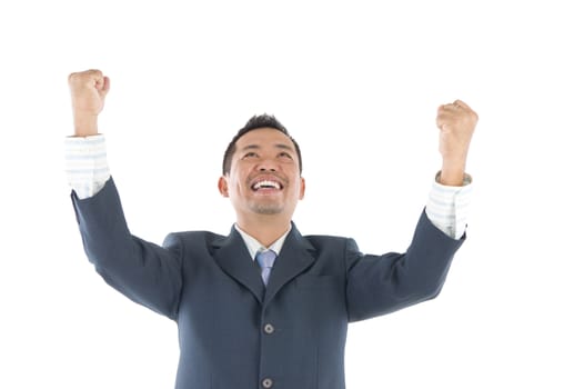 Portrait of excited asian indonesian businessman celebrating success over white background
