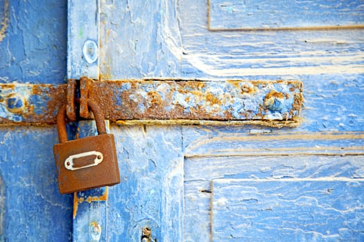 morocco in africa the old wood  facade home and rusty safe padlock 