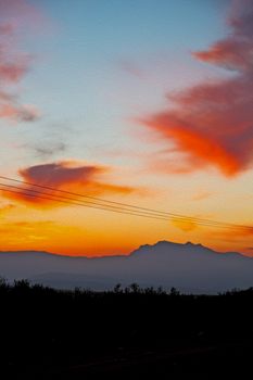 mountain in morocco africa and red sunrise current cables   power pylon