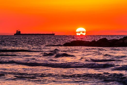 maritime landscape, large ship on sunset background