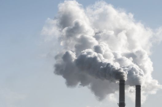 industrial smoke from chimney on blue sky