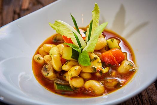 Baked beans in tomato sauce on plate.  Healthy  food, vegan or diet nutrition concept.