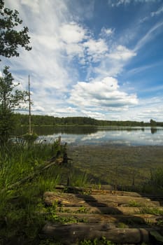 Beautiful landscape with a lake. the mirror surface of the water reflects the blue sky