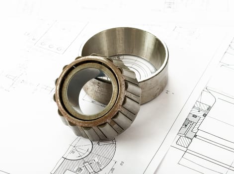 Roller bearing on blue prints, side view