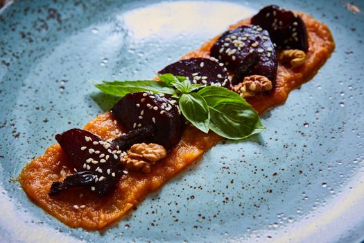 roasted vegetables: beets with pumpkin puree. Shallow dof