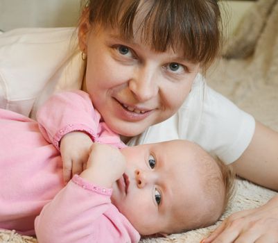 Happy cheerful family. Mother and baby kissing, laughing and hugging