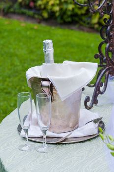 Two stem glasses and a spumante bottle for a toast during a wedding
