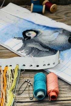 Set of threads for embroidery on background of handmade paintings