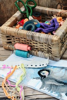 Set of threads for embroidery on background of handmade paintings