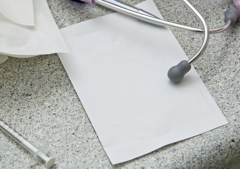 Stethoscope and blank paper for notes