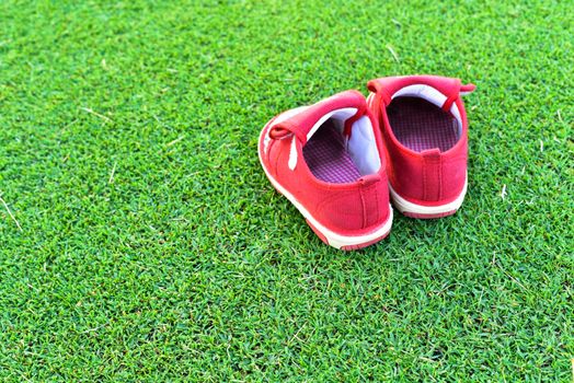 Little red shoes on grass