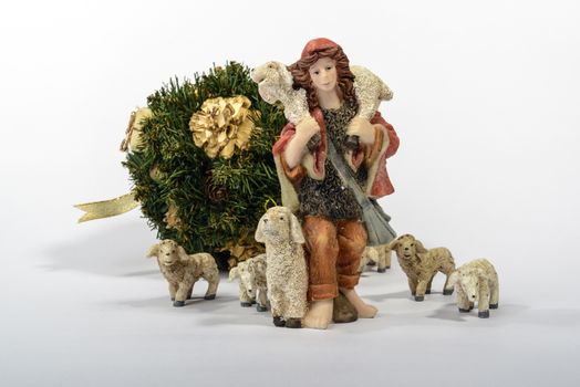 Shepherd with his sheep, element of the Christmas nativity. White background with the Christmas decorations.