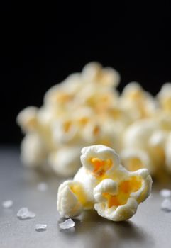 Popcorn and salt isolated on black background