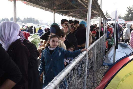 GREECE, Idomeni: Migrants line up near the Greek village of Idomeni, on March 2, 2016. The migrants are waiting for the Macedonian authorities to open the border so they can continue their journey through Europe.