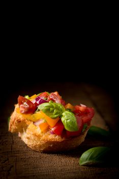 Colorful bruschetta on a rustic background.  Useful for many food service promotional applications.