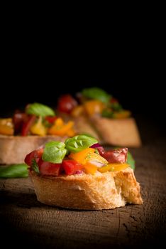 Colorful bruschetta on a rustic background suitable for a variety of food service applications.