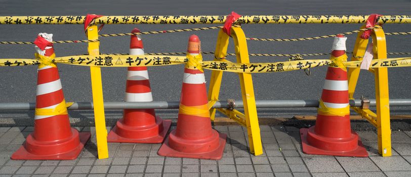 close up of bright red and yellow security safety barrier