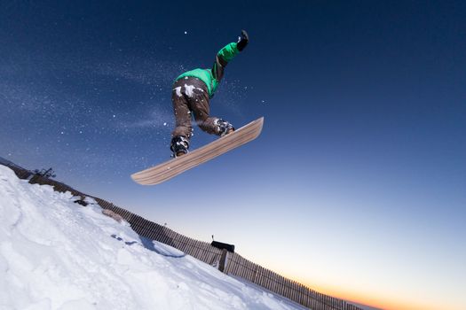 Young man snowboarding in the mountains.