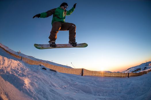 Young man snowboarding in the mountains.