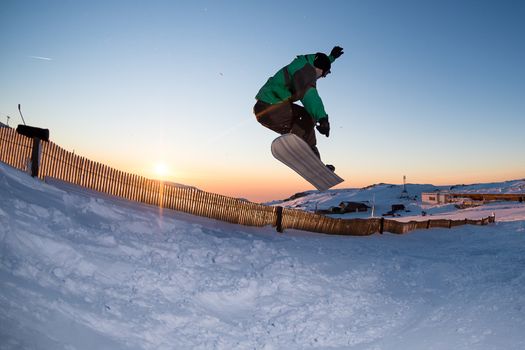 Young man snowboarding in the mountains.