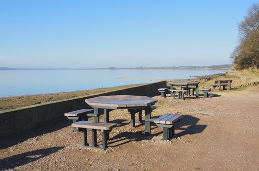 Picnic tables by edge of Estuary
