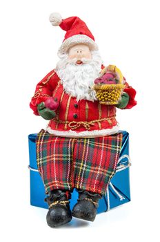 Santa Claus figure sitting on a gift box isolated on white background with clipping path