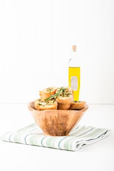 Bowl of rosemary and olive oil crostini.  Useful for many food service marketing applications.
