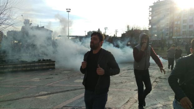 TURKEY, Diyarbakir : People run away from tear gas during clashes between Turkish forces and Kurdish people in the centre of Diyarbakir during a protest against a curfew in the Sur district of Diyarbakir, on March 2, 2016.
Ankara has repeatedly imposed curfews for military operations in southeastern urban centres, in a measure the government says is necessary to root out PKK militants who were taking de-facto control in some areas. The Cizre curfew was one of the longest but a lockdown has also been in place since December 2 in the central Sur district which is home Turkey's biggest Kurdish majority city, Diyarbakir. According to the HDP, 25 citizens have been killed during the Sur curfew while several centuries-old historic and religious buildings have been destroyed. 