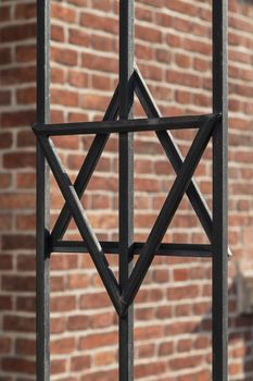 Star of David on metal fence of Old Synagogue in jewish district of Cracow - Kazimierz on Szeroka street in Poland