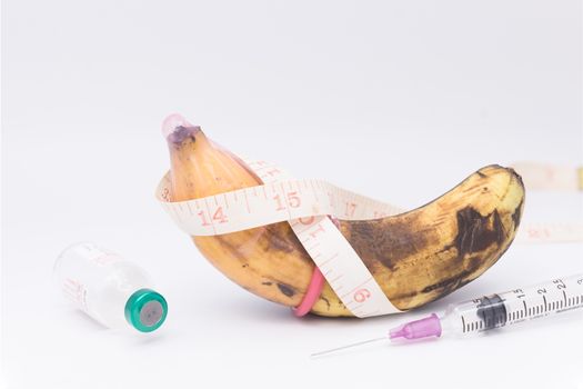 rotten bananas in condom with measuring tape,upsize penis concept