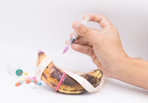rotten banana in condom with hand injection,sexually transmitted disease concept