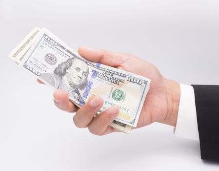 US dollars in business hand isolated on a white background