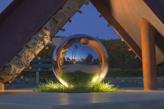 Laguna Beach, California, December 25, 2015: A reflecting ball sculpture in Heisler Park, Laguna Beach, California, at sunset, titled “Semper Memento” and created by artist Jorg Dubin in 2011