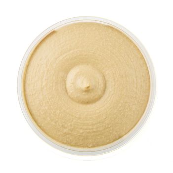Healthy hummus in container from above and isolated on a white background.
