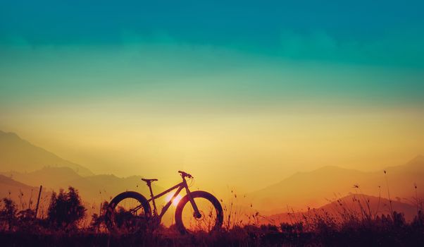 Golden sky sunset and mountain bike silhouette, silhouette fat bike, Silhouette Bicycle  on mountain background