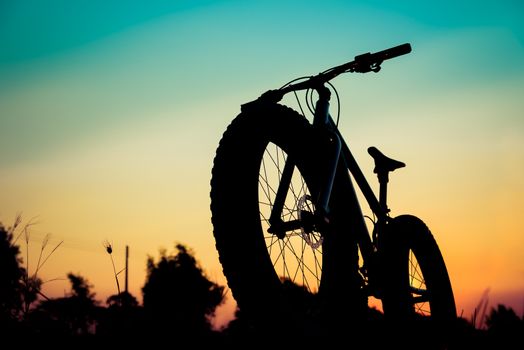mountain bike silhouette on beautiful sunset, silhouette fatbike