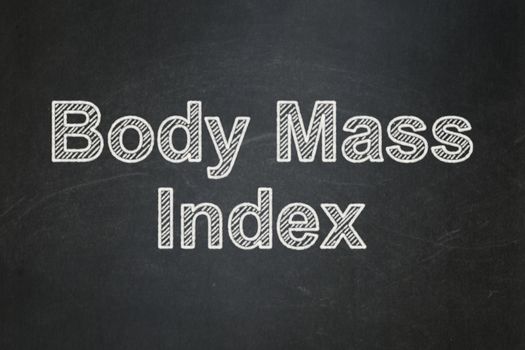 Health concept: text Body Mass Index on Black chalkboard background