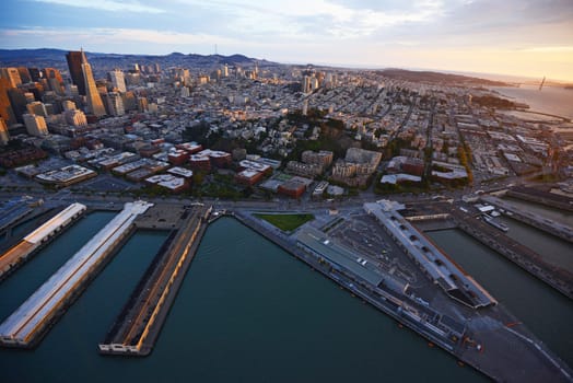 an aerial view of downtown san francisco with pier during sunset