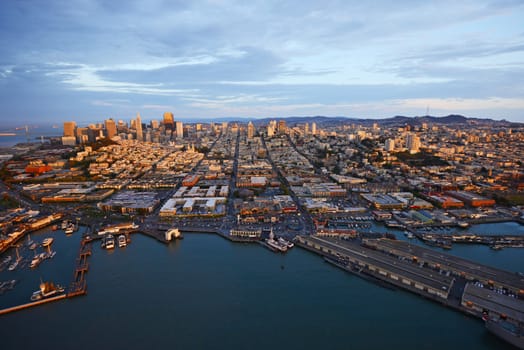 an aerial view of downtown san francisco with pier during sunset