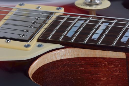 Detailed view on the nice brown electric guitar