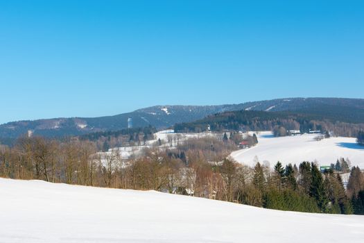 Snowy mountain landscape with blue sky