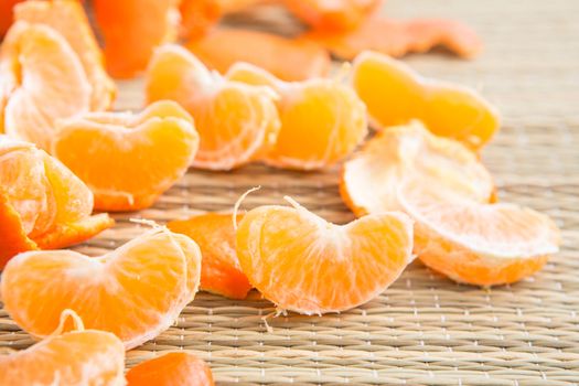 Peeled slices of tangerine on the Mat, separate