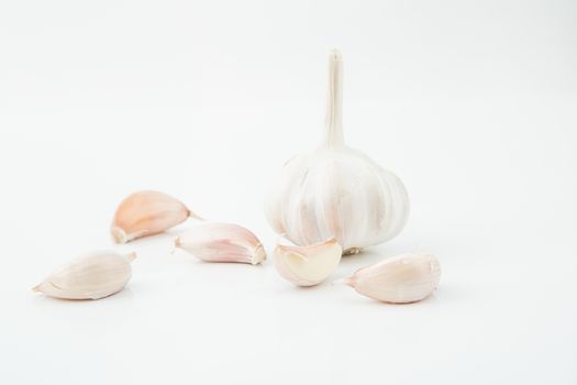 many cloves of garlic on white background