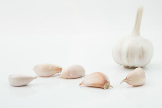 many cloves of garlic on white background