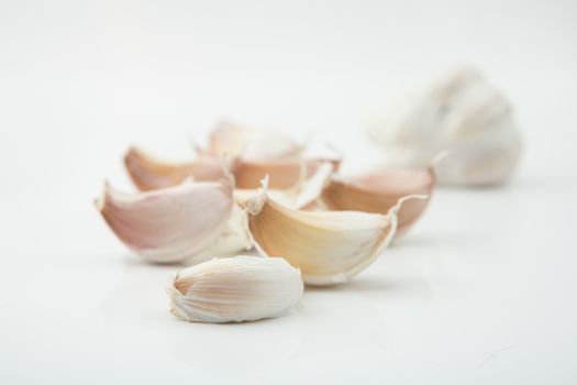 many cloves of garlic on white background