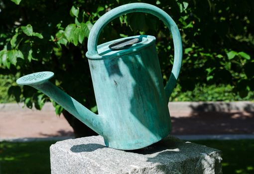 one old watering can on a stone beutiful decoration